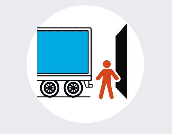 person between a trailer and dock door